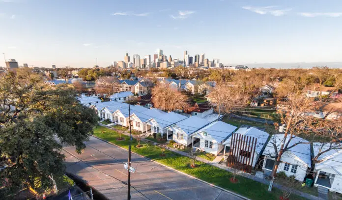 An aerial view of Project Row Houses with the Downtown skyline in the background