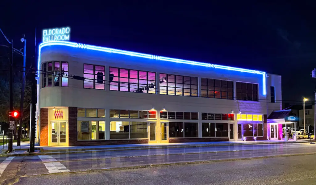 Exterior of Eldorado Ballroom at night with blue neon lights along the roof