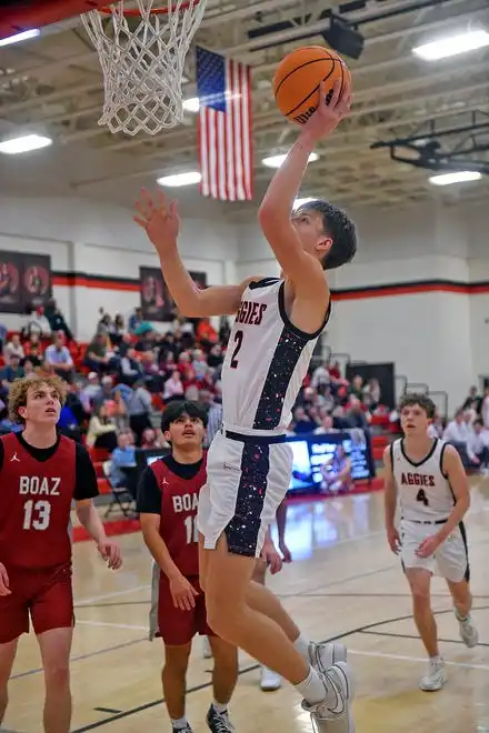 Albertville's John Mccullars makes a shot as Boaz's Amin Cruz defends during high school basketball action in Albertville, Alabama January 29, 2024.