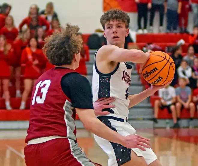 Albertville's Samuel Barclift looks for an open pass as Boaz's Judd Oliver defends during high school basketball action in Albertville, Alabama January 29, 2024.