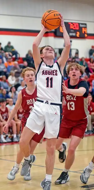 Albertville's Tyler Snider makes a shot as Boaz's Judd Oliver defends during high school basketball action in Albertville, Alabama January 29, 2024.