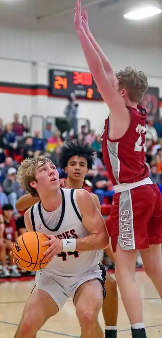 Albertville's John Wesley Seay makes a shot as Boaz's Landon Cannady defends during high school basketball action in Albertville, Alabama January 29, 2024.