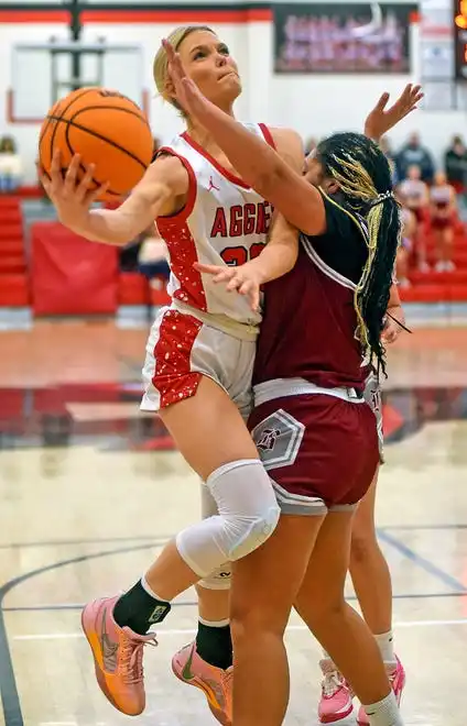 Albertville’s Molly Morrison makes a shot as Boaz’s Jazira Roberts defends during high school basketball action in Albertville, Alabama January 29, 2024.