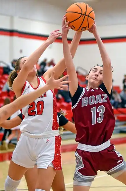 Albertville's Gracyn Robeson and Boaz's Lillac Stanton battle for a rebound during high school basketball action in Albertville, Alabama January 29, 2024.