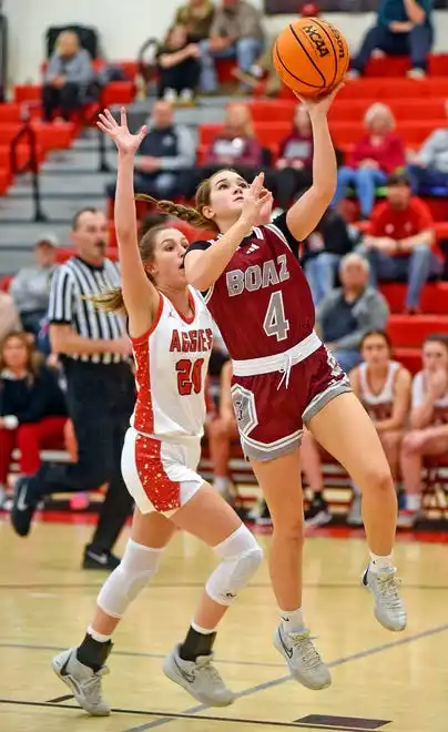 Boaz's Sydney Noles makes a shot as Albertville's Gracyn Robeson defends during high school basketball action in Albertville, Alabama January 29, 2024.