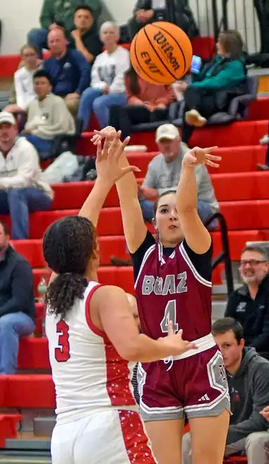 Boaz's Sydney Noles makes a shot as Albertville's Bailey Jarrell defends during high school basketball action in Albertville, Alabama January 29, 2024.