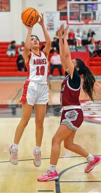 Albertville's Dana Fuentes makes a shot as Boaz's Mollie Brock defends during high school basketball action in Albertville, Alabama January 29, 2024.