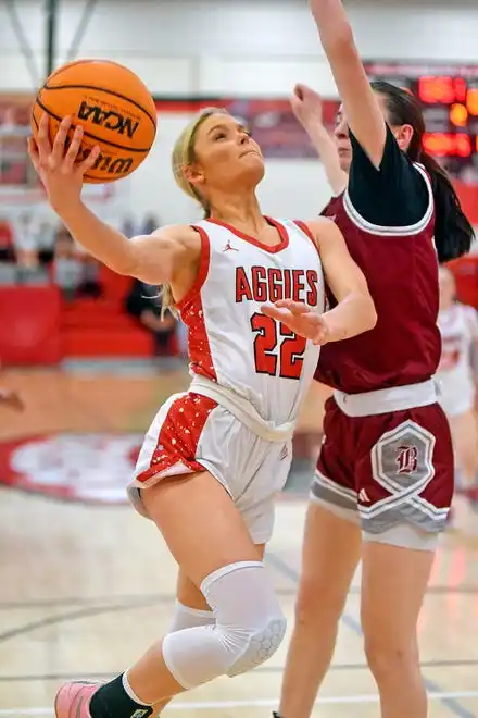 Albertville's Molly Morrison makes a shot as Boaz's Lillac Stanton defends during high school basketball action in Albertville, Alabama January 29, 2024.