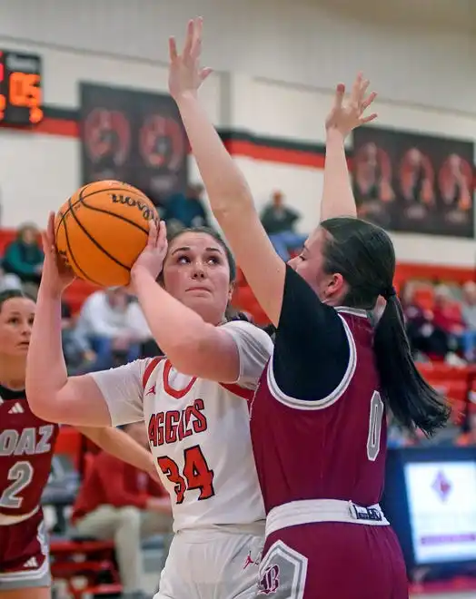 Albertville's Hannah Burson makes a shot as Boaz's Harley Wyatt defends during high school basketball action in Albertville, Alabama January 29, 2024.