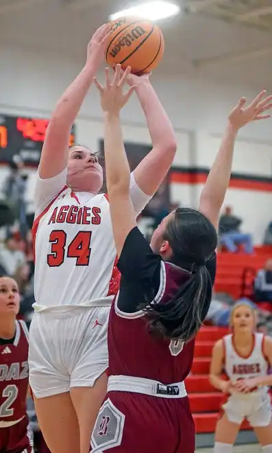 Albertville's Hannah Burson makes a shot as Boaz's Harley Wyatt defends during high school basketball action in Albertville, Alabama January 29, 2024.