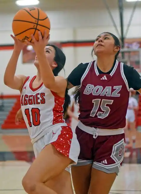 Albertville's Dana Fuentes makes a shot as Boaz's Mckenzie Garcia defends during high school basketball action in Albertville, Alabama January 29, 2024.