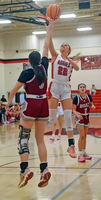 Albertville's Molly Morrison makes a shot as Boaz's Harley Wyatt defends during high school basketball action in Albertville, Alabama January 29, 2024.