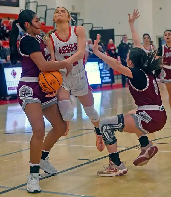 Albertville's Molly Morrison is fouled by Boaz's Mckenzie Garcia defends during high school basketball action in Albertville, Alabama January 29, 2024.