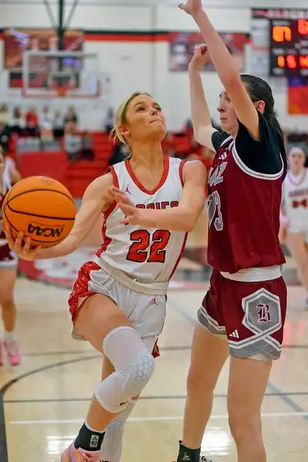 Albertville's Molly Morrison makes a shot as Boaz's Lillac Stanton defends during high school basketball action in Albertville, Alabama January 29, 2024.