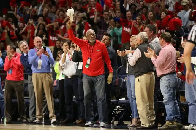 Jan 23, 2018; Oxford, MS, USA; Morgan Freeman (C) waves to the crowd after being recognized for receiving the Lifetime Achievement Award from the Screen Actors Guild during the first half between the Mississippi Rebels and the Alabama Crimson Tide at The Pavilion at Ole Miss. Mandatory Credit: Spruce Derden-USA TODAY Sports