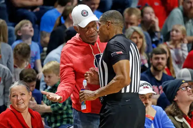 Dec 15, 2021; Oxford, Mississippi, USA; Morgan Freeman talks to a referee during a timeout during the first half of the Middle Tennessee Blue Raiders and the Mississippi Rebels game at The Sandy and John Black Pavilion at Ole Miss. Mandatory Credit: Petre Thomas-USA TODAY Sports