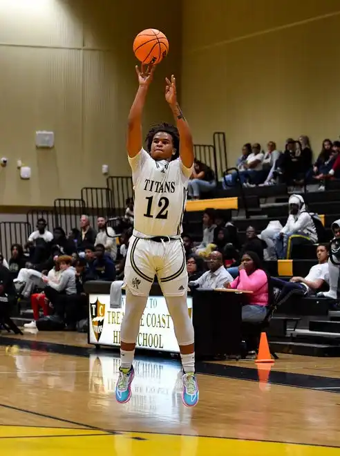 Treasure Coast's Dejuan Preston (12) attempts a three pointer in a boys high school basketball game against Okeechobee, Tuesday, Jan. 30, 2024, in Port St. Lucie.