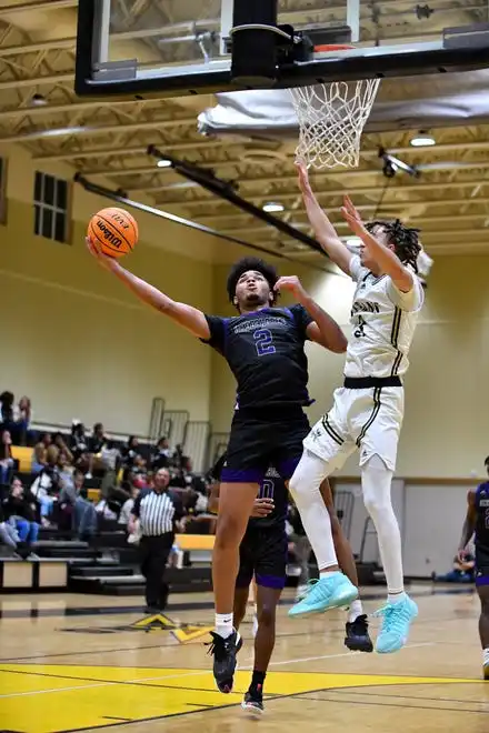 Okeechobee's Oliver Saunders (2) attempts a layup over Treasure Coast's Tyson Wilson (3) in a boys high school basketball game, Tuesday, Jan. 30, 2024, in Port St. Lucie.