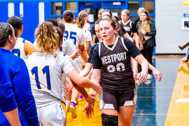 Westport's Sarah Perry leads the post game handshake line.