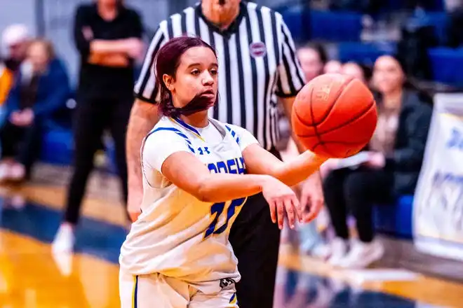 Wraeham's Lexi Powell-Gomes moves the ball around the court.