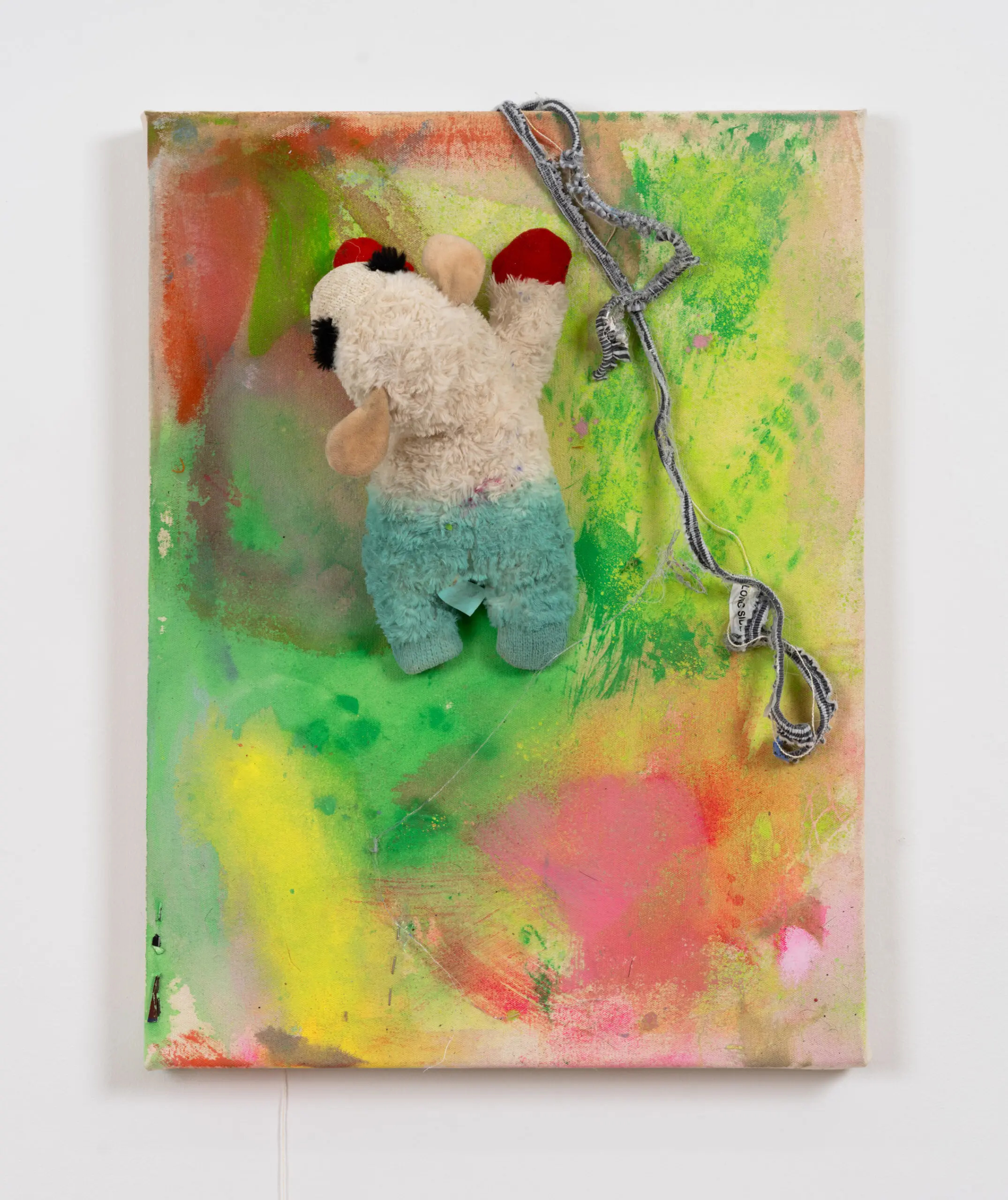 A colorful painting with a Lambchop toy embedded in it