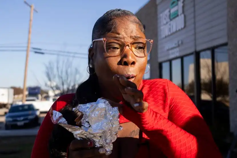 Ericka Watson is excited after taking a bite of her Nihari X Birria Taco order from Halal...