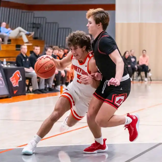 Hartford's Braycen Burg (5) tries to muscle past Homestead's Tommy O'Hagan (1) during the game at Hartford, Tuesday, Jan. 30, 2024.