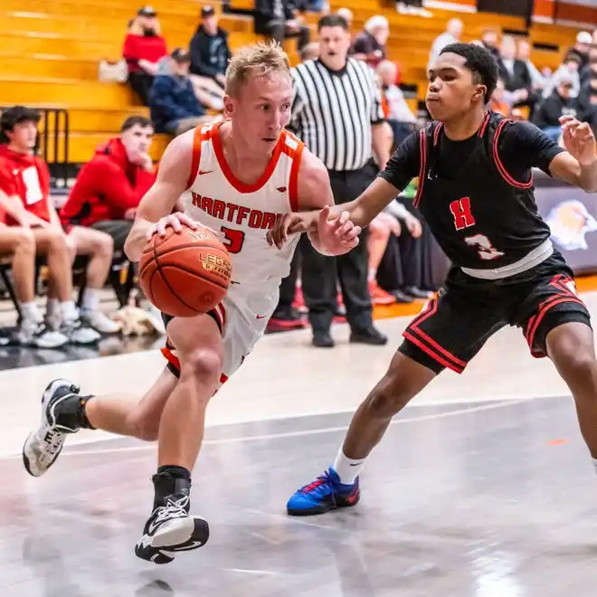 Hartford's RJ Thomae, left, breaks past Homestead's Michael Rogers Jr. (3) during the game at Hartford, Tuesday, Jan. 30, 2024.