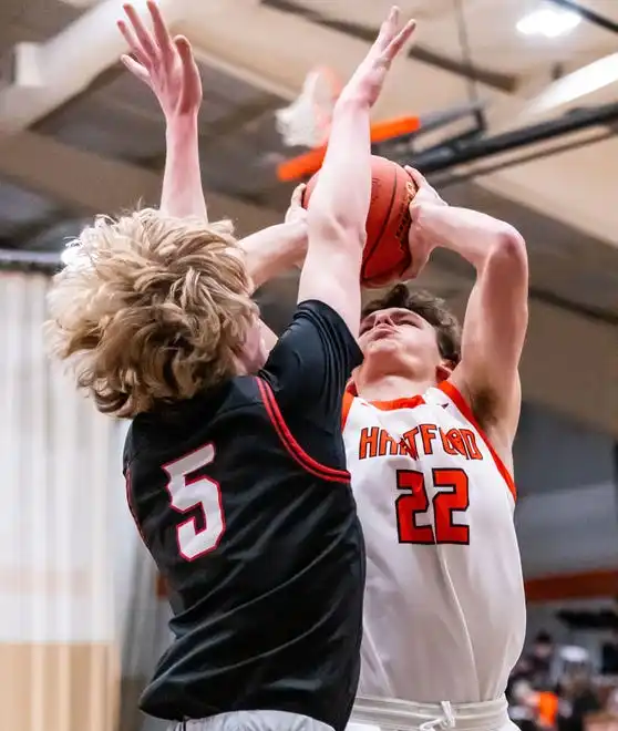 Hartford's Joe Landgraf (22) elevates for two over Homestead's Tim Franks (5) during the game at Hartford, Tuesday, Jan. 30, 2024.