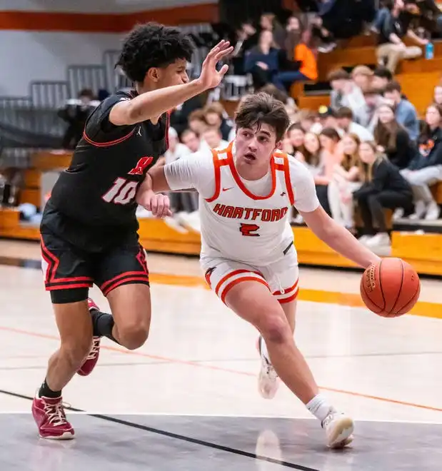 Hartford's Zach Herrmann (2) tries to muscle past Homestead's Trevor Polite (10) during the game at Hartford, Tuesday, Jan. 30, 2024.