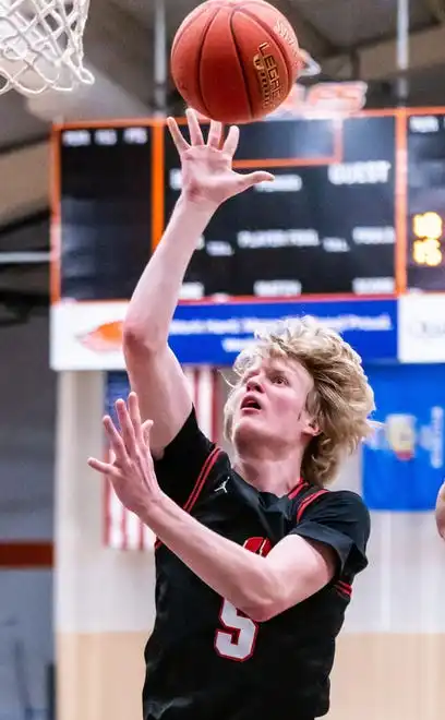 Homestead's Tim Franks (5) elevates for a shot at Hartford, Tuesday, Jan. 30, 2024.