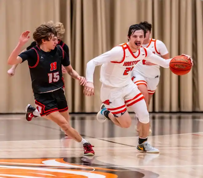 Hartford's Wyatt Carlson (24) races Homestead's Andrew Hinterstocker (15) downcourt during the game at Hartford, Tuesday, Jan. 30, 2024.