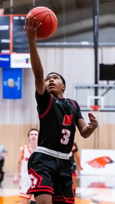 Homestead's Michael Rogers Jr. (3) drives in for a layup at Hartford, Tuesday, Jan. 30, 2024.