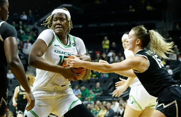 Oregon center Phillipina Kyei, fights for possession against Colorado guard Kindyll Wetta, in an NCAA college basketball game in Eugene, Ore., Sunday, Jan. 28, 2024. (AP Photo/Thomas Boyd)