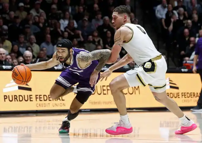 Northwestern Wildcats guard Boo Buie (0) drives past Purdue Boilermakers forward Mason Gillis (0) during the NCAA men’s basketball game, Wednesday, Jan. 31, 2024, at Mackey Arena in West Lafayette, Ind.