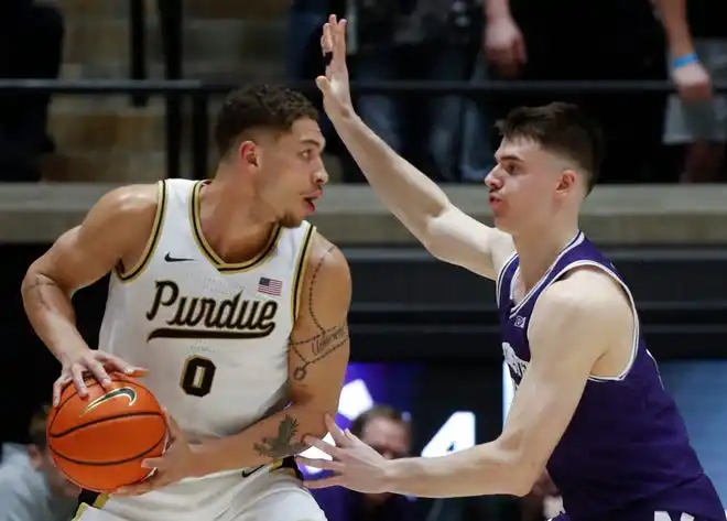 Purdue Boilermakers forward Mason Gillis (0) is guarded by Northwestern Wildcats guard Brooks Barnhizer (13) during the NCAA men’s basketball game, Wednesday, Jan. 31, 2024, at Mackey Arena in West Lafayette, Ind.