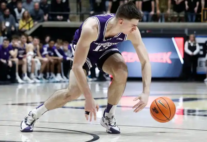 Northwestern Wildcats guard Brooks Barnhizer (13) loses control of the ball during the NCAA men’s basketball game against the Purdue Boilermakers, Wednesday, Jan. 31, 2024, at Mackey Arena in West Lafayette, Ind.