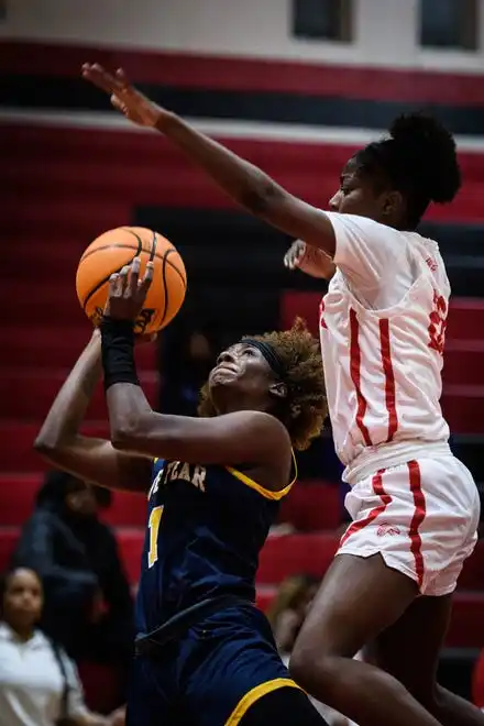 Cape Fear’s Jayda Angel goes up for a shot with Seventy-First’s Kariana Williams covering her during the second quarter on Wednesday, Jan. 31, 2024, at Seventy-First High School.