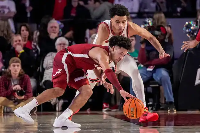 Jan 31, 2024; Athens, Georgia, USA; Alabama Crimson Tide guard Mark Sears (1) tries to control the ball against Georgia Bulldogs guard Jabri Abdur-Rahim (1) during the first half at Stegeman Coliseum. Mandatory Credit: Dale Zanine-USA TODAY Sports