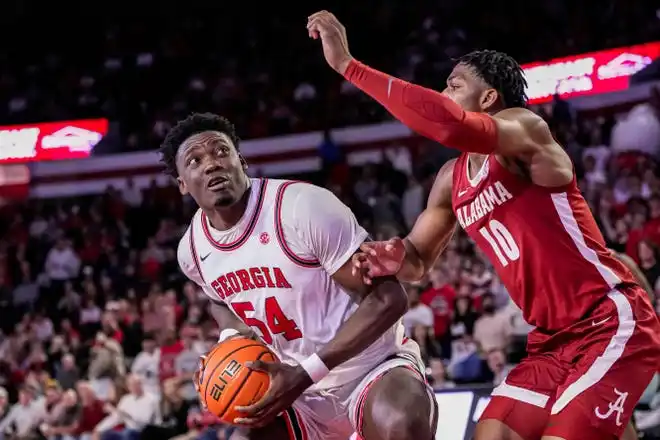 Jan 31, 2024; Athens, Georgia, USA; Georgia Bulldogs center Russel Tchewa (54) looks for a shot against Alabama Crimson Tide forward Mouhamed Dioubate (10) during the first half at Stegeman Coliseum. Mandatory Credit: Dale Zanine-USA TODAY Sports