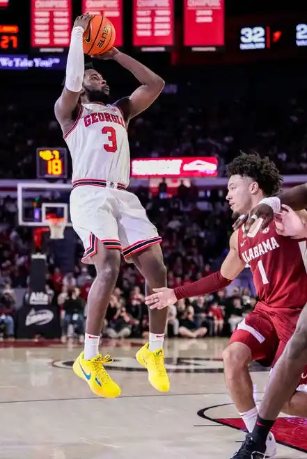 Jan 31, 2024; Athens, Georgia, USA; Georgia Bulldogs guard Noah Thomasson (3) shoots over Alabama Crimson Tide guard Mark Sears (1) during the first half at Stegeman Coliseum. Mandatory Credit: Dale Zanine-USA TODAY Sports