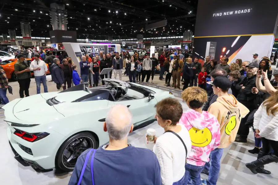 Crowds admire a car on display at the Chicago Auto Show