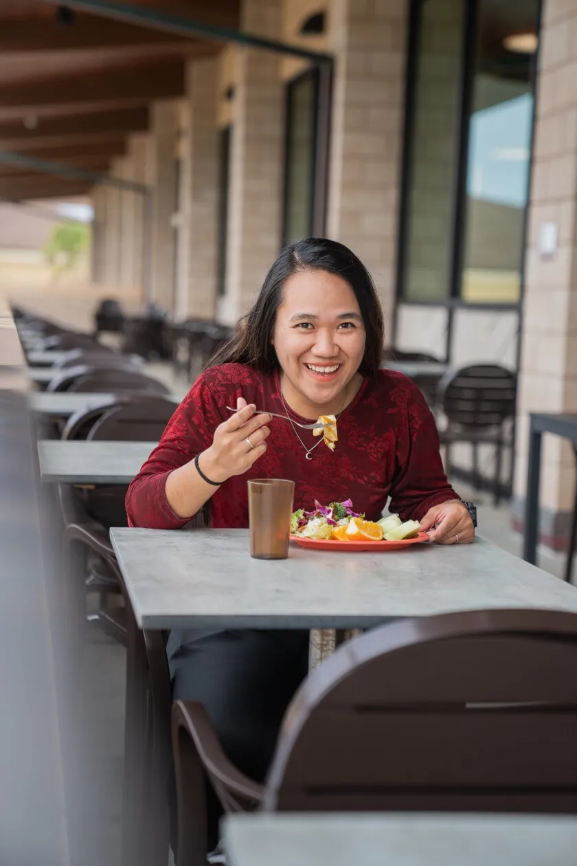 Martinez smiles and eats healthy food.