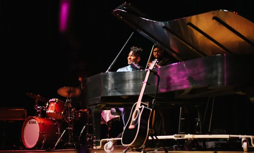 Jon Batiste plays piano at CMA