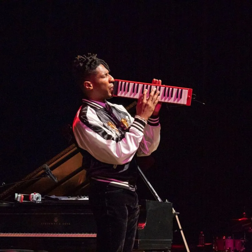 Jon Batiste plays harmonaboard