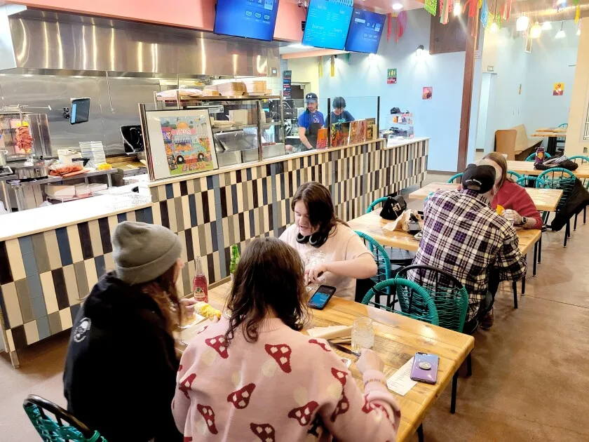 People dine in a taqueria.