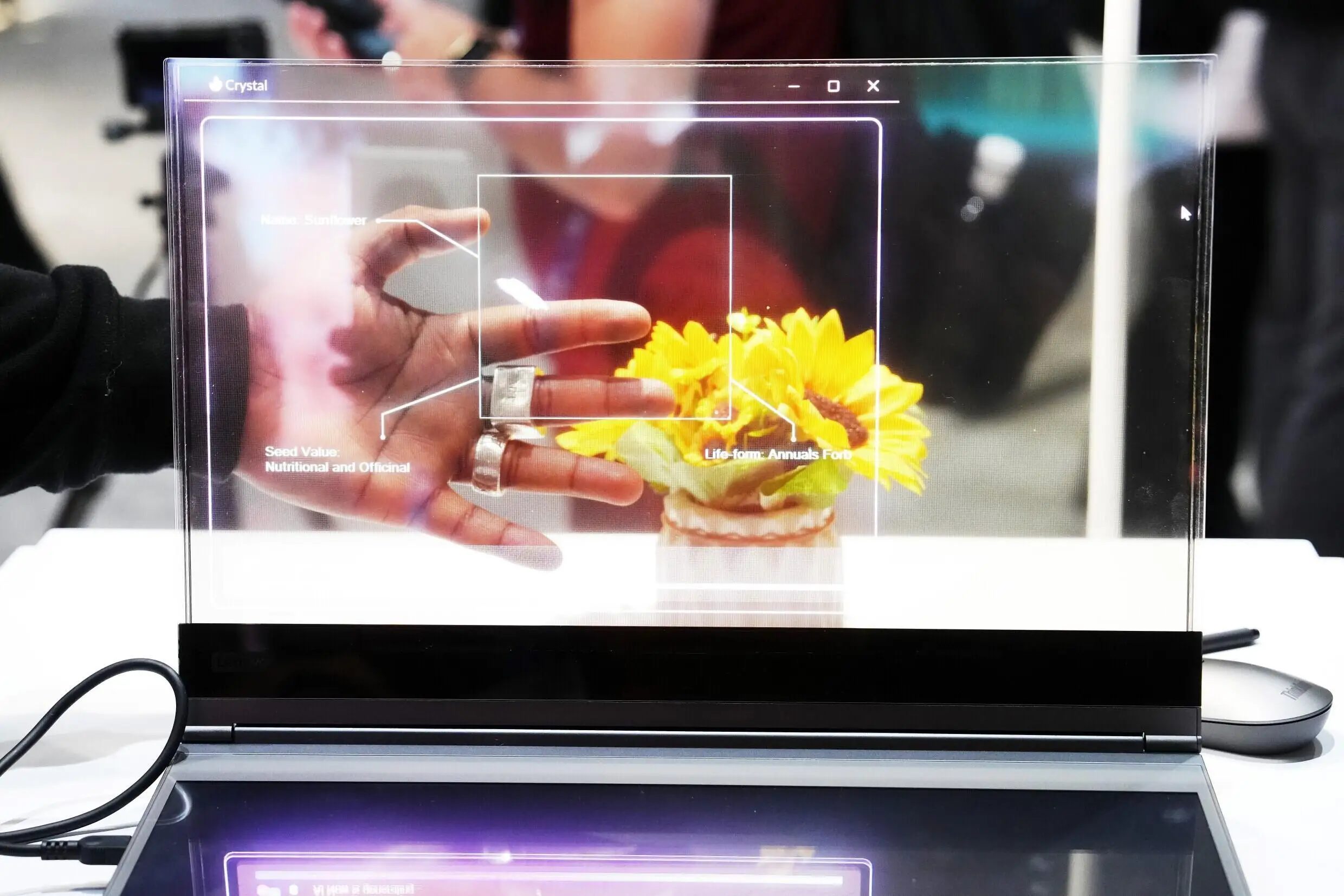 A visitor tests the transparent display of new Lenovo ThinkBook laptop on the first day of the Mobile World Congress (MWC) in Barcelona