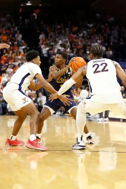 Jan 31, 2024; Charlottesville, Virginia, USA; Notre Dame Fighting Irish guard Markus Burton (3) controls the ball between Virginia Cavaliers guard Reece Beekman (2) and Cavaliers forward Jordan Minor (22) during the first half at John Paul Jones Arena. Mandatory Credit: Amber Searls-USA TODAY Sports