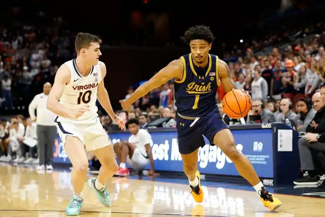 Jan 31, 2024; Charlottesville, Virginia, USA; Notre Dame Fighting Irish guard Julian Roper II (1) dribbles the ball as Virginia Cavaliers guard Taine Murray (10) defends during the first half at John Paul Jones Arena. Mandatory Credit: Amber Searls-USA TODAY Sports