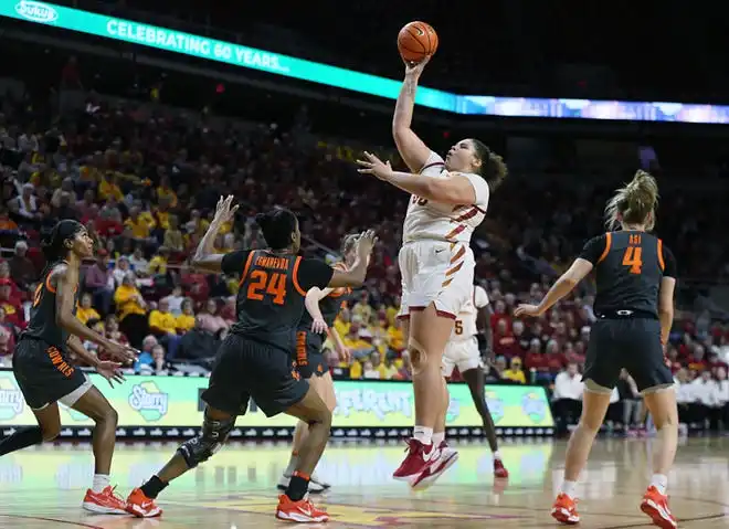 Iowa State Cyclones center Audi Crooks (55) takes a shot over Oklahoma State Cowgirls forward Praise Egharevba (24) during the first quarter in the Big-12 conference matchup at Hilton Coliseum on Wednesday, Jan. 31, 2024, in Ames, Iowa.